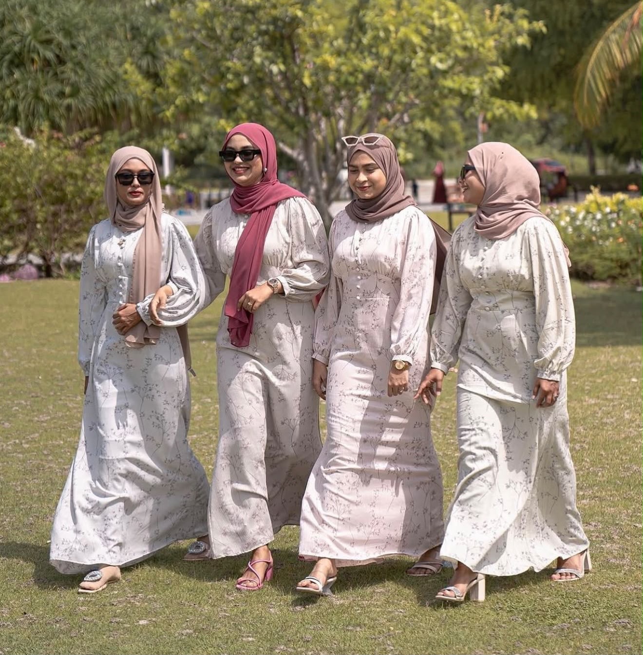 Four women wearing Edmee Maldives floral long dresses and hijabs